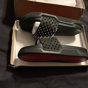 Black with silver studs n red bottoms in perfect condition I will negotiate